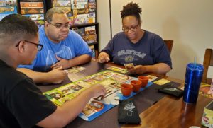 Our Family Plays Games playing a board game